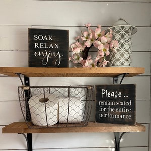 Please remain seated, wood sign