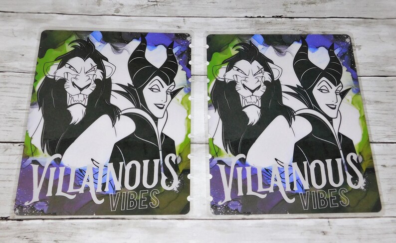 May include: Two planner dashboards featuring illustrations of Scar from The Lion King and Maleficent. The text "Villainous Vibes" is displayed in white. The background has a watercolor effect with green, blue, and purple hues.