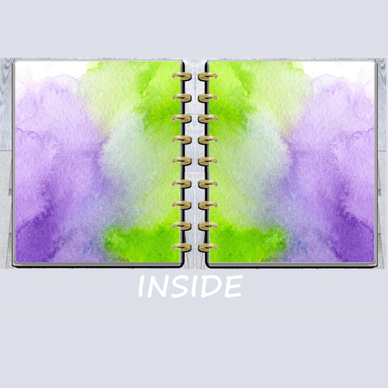 May include: Open notebook with watercolor-style pages. The left page features a purple and blue watercolor wash, while the right page has a green and yellow wash. The word "INSIDE" is printed in white.