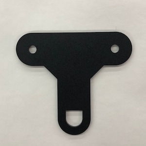May include: Black metal T-shaped bracket with two holes on the top and a single hole on the bottom.