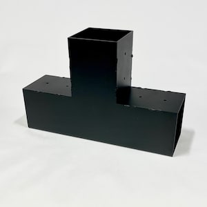May include: Black metal T-shaped bracket with multiple holes. The bracket is designed for structural support.