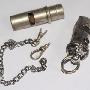 Two antique whistles.