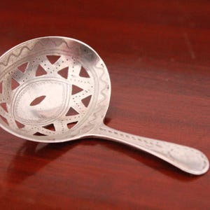 Silver tea caddy spoon, pierced design, Georgian.