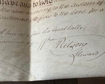 May include: A close-up of a handwritten document with the text "A true copy from the Court Rolls;" and a signature that reads "W: Ritzons Steward".