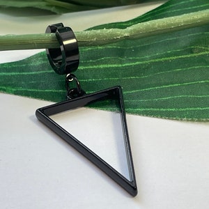 May include: Black triangle earring with a hoop. The earring is made of metal and has a simple design.