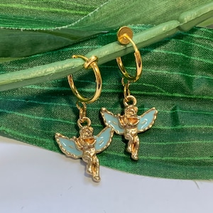 May include: A pair of gold hoop earrings with a blue enamel angel charm hanging from each hoop.