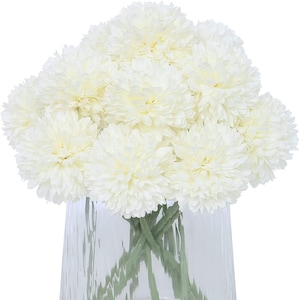Puede incluir: Un ramo de crisantemos artificiales blancos en un jarrón de vidrio transparente. Las flores están dispuestas en un racimo y tienen una apariencia esponjosa, similar a un pompón.