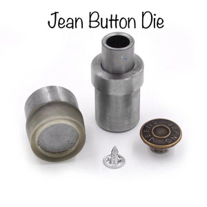 May include: A set of metal tools for attaching jeans buttons. The set includes a die, a punch, and a button. The button is a brass-colored metal button with the word "JEANS" embossed on it.