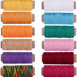 May include: A set of 12 spools of waxed thread in various colors, including yellow, orange, white, blue, green, pink, purple, red, and a multi-colored spool. The spools are arranged in two rows of six, with the spools in each row alternating colors.