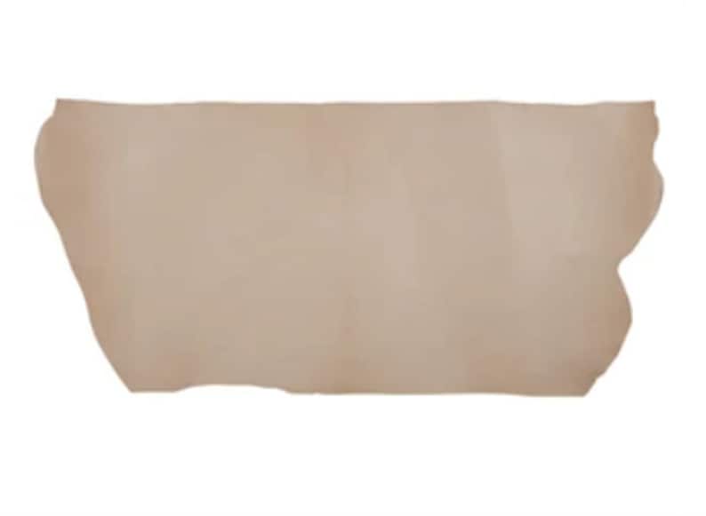 May include: A piece of light brown leather with an irregular shape.
