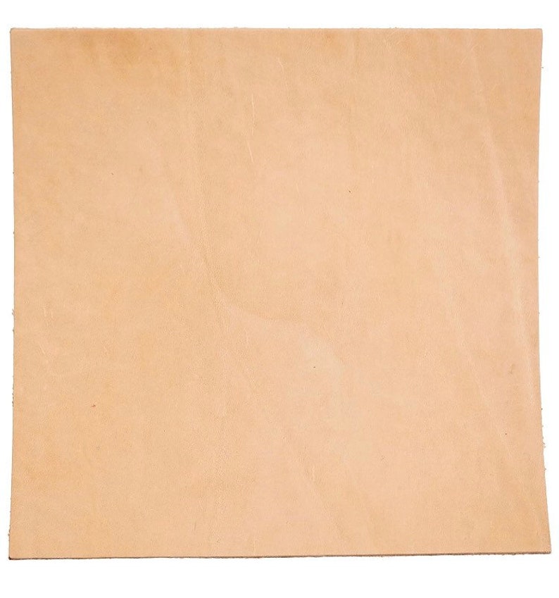 May include: A piece of natural leather in a light tan color. The leather is smooth and has a slight sheen.