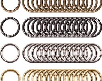 May include: A set of 40 metal key rings in three different finishes: gold, silver, and black. The key rings are all the same size and shape, and they are arranged in four rows of ten.