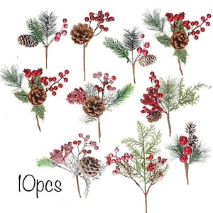 May include: Ten artificial Christmas sprigs with pine needles, red berries, and pine cones. The sprigs are dusted with faux snow.