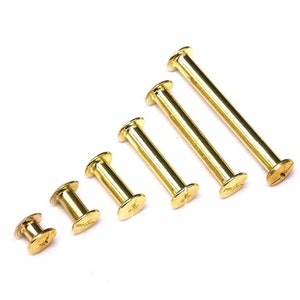 May include: A set of six gold-toned metal screw-in posts of varying lengths. The posts have a flat head and a threaded shank.