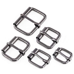 May include: Four black metal belt buckles of different sizes. The buckles are rectangular with a smooth finish.