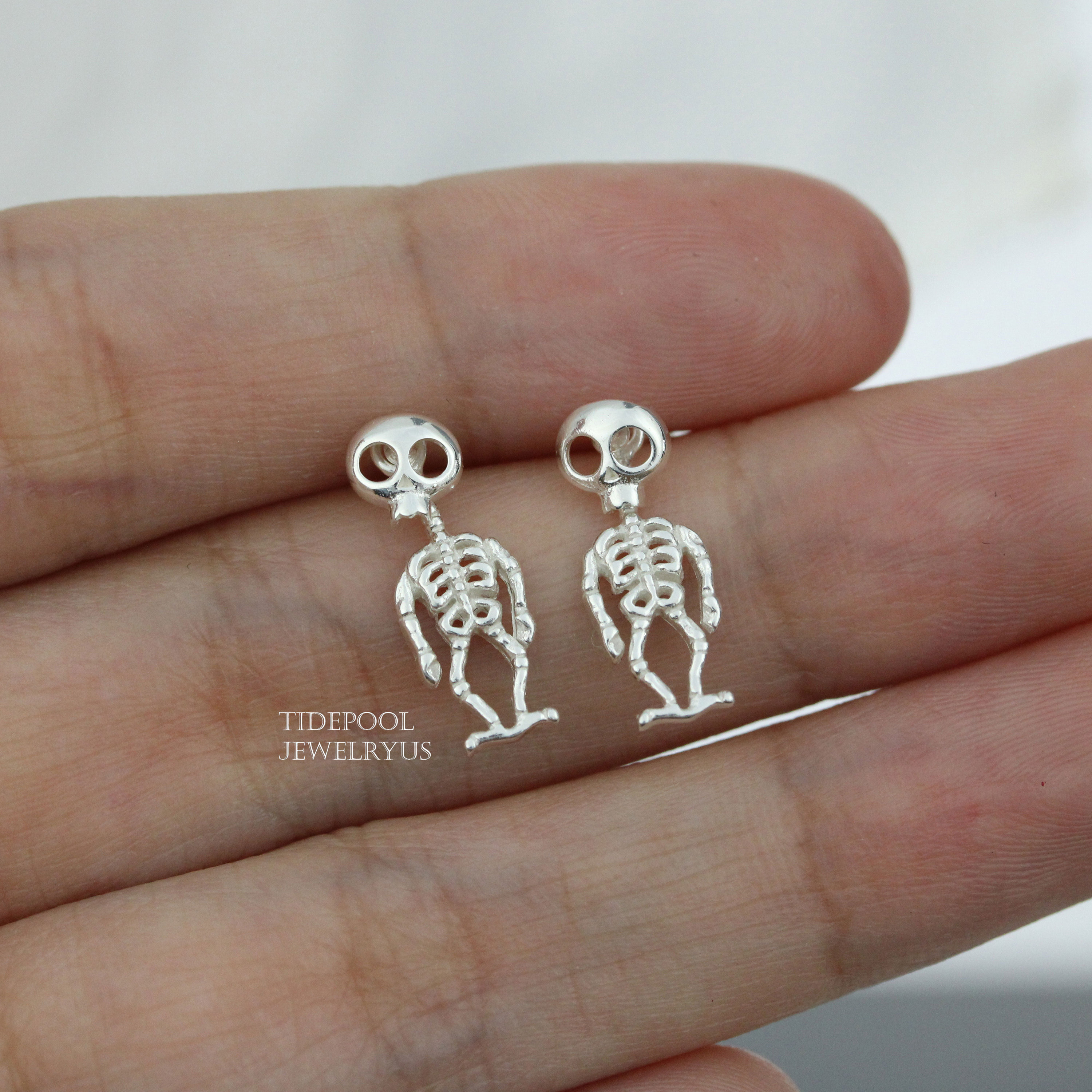 Skeleton stud earrings deals