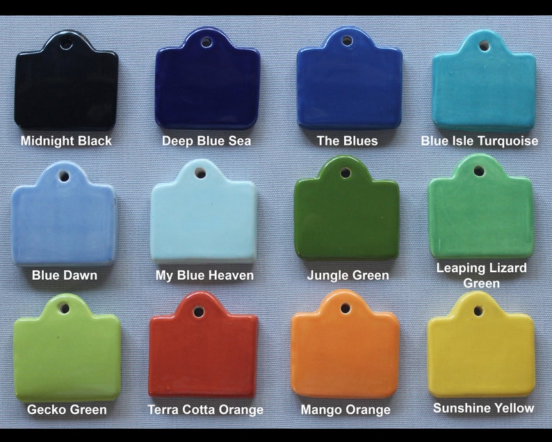 May include: Twelve ceramic tiles with different colors and names. The tiles are arranged in four rows of three tiles each. The colors are midnight black, deep blue sea, the blues, blue isle turquoise, blue dawn, my blue heaven, jungle green, leaping lizard green, gecko green, terra cotta orange, mango orange, and sunshine yellow.