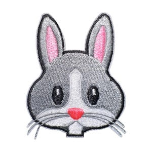 May include: Embroidered iron-on patch of a grey bunny rabbit with pink ears and a red nose.