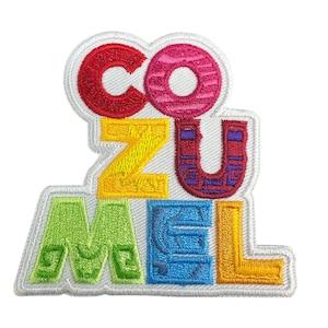 May include: Embroidered patch spelling "COZUMEL" in vibrant block letters. The letters are outlined in white and filled with red, pink, yellow, purple, green, blue, and orange. A colourful patch, possibly for a travel souvenir or to be sewn onto clothing.