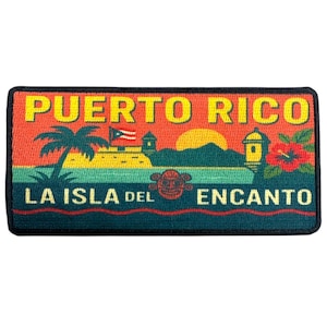 May include: A rectangular patch featuring the words "PUERTO RICO" in yellow above "LA ISLA DEL ENCANTO" in blue. The design includes a palm tree, a fort, and the Puerto Rican flag against a sunset backdrop.