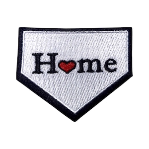 May include: White embroidered patch with a black outline in the shape of a baseball diamond. The patch says "Home" with a red heart in place of the "o".