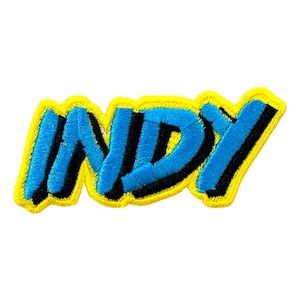 Op de afbeelding: Een geborduurde patch met het woord "INDY" in blauwe en zwarte letters, omrand met geel.