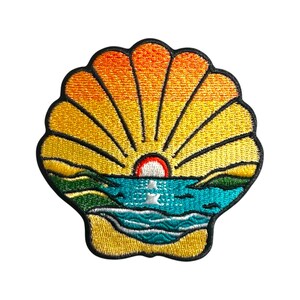 May include: An embroidered patch shaped like a seashell with a sunset scene inside. The seashell is yellow with orange and red hues. The sunset is orange and red with a blue ocean and green hills in the foreground.