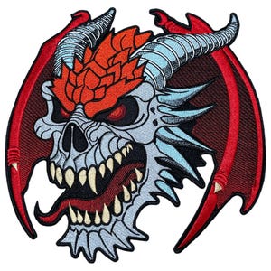 May include: A red and blue embroidered patch of a dragon skull with sharp teeth and horns. The dragon has red wings with black outlines.