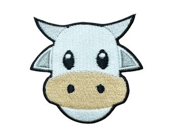 May include: White embroidered patch of a cow's face with black eyes and a tan nose.