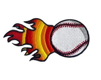 May include: An embroidered patch of a baseball on fire. The baseball is white with red stitching and the flames are red, orange, and yellow.