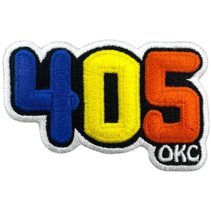 May include: Embroidered patch featuring the numbers "405" in blue, yellow, and orange, with "OKC" below. The patch has a black border and a white outline, suitable for jackets, bags, or other fabric items.