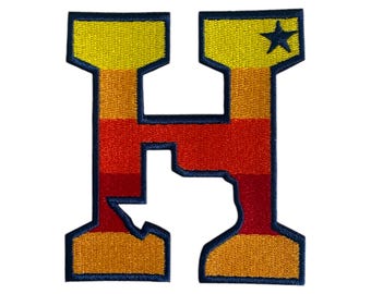 May include: Embroidered patch in the shape of the letter "H", with a yellow, orange, and red gradient design. A blue star is in the upper right corner. The patch has a blue border.