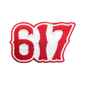May include: Embroidered patch featuring the number "617" in white on a red background. The patch has a decorative, curved border in white. The numbers are in a bold, stylized font, suitable for jackets, bags, or other apparel.