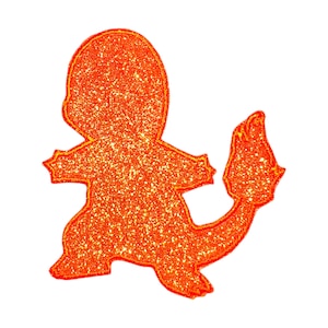 May include: Glittery orange Charmander silhouette on a white background. The outline of the Pokémon character is filled with sparkling glitter, and the tail flame is clearly visible. The image is a graphic design of a popular character.