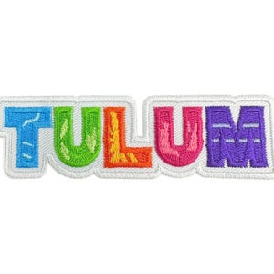 May include: Embroidered patch with the word "TULUM" in colorful letters. The letters are blue, green, orange, pink, and purple, outlined in white. The patch has a white border and is likely for clothing or accessories.