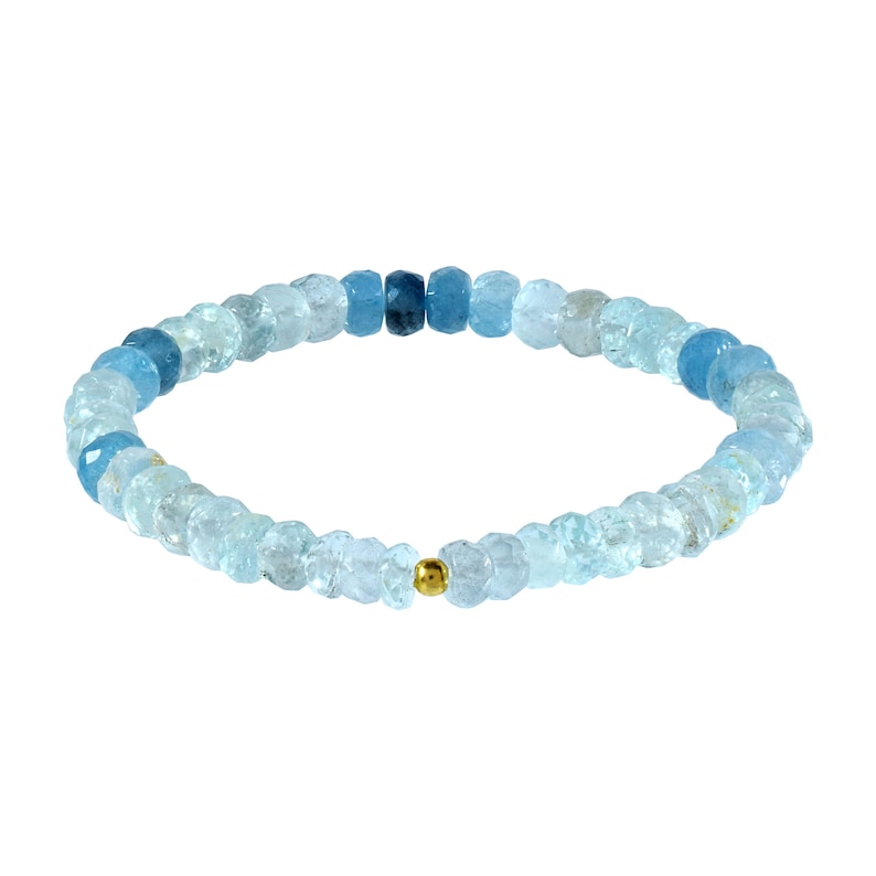 May include: A light blue aquamarine gemstone bracelet with a gold bead accent. The bracelet is made of small, faceted beads that are graduated in size, creating a gradient effect.