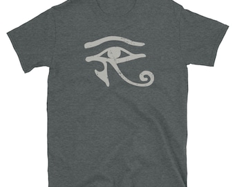 May include: A dark heather grey t-shirt with a white print of the Eye of Horus, an ancient Egyptian symbol.
