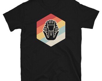 May include: Black t-shirt featuring a retro-style graphic of a pharaoh's head within a hexagon, with a rainbow colour scheme.