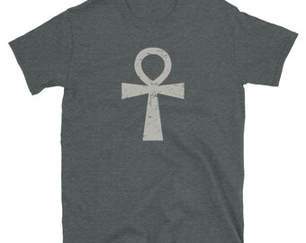 May include: A dark heather grey t-shirt with a white Ankh symbol printed on the front. The symbol has a distressed, vintage look.