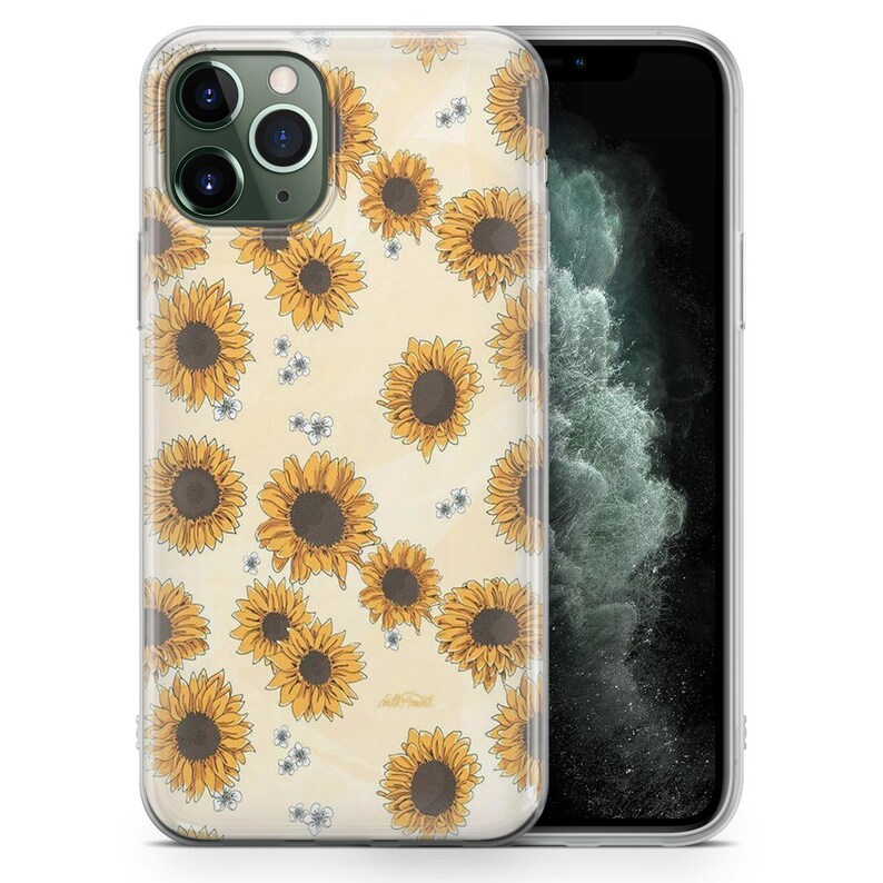 Puede incluir: Una funda transparente para tel&eacute;fono con un patr&oacute;n de girasoles amarillos sobre un fondo crema. La funda est&aacute; dise&ntilde;ada para un iPhone 11 Pro.