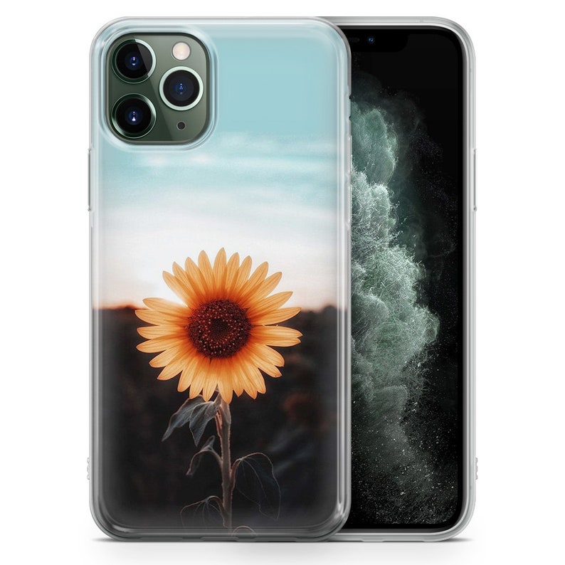 Puede incluir: Una funda transparente para tel&eacute;fono con un dise&ntilde;o de girasol. El girasol es amarillo con un centro marr&oacute;n y se coloca sobre un fondo de cielo azul.