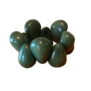May include: A green jade bracelet made of smooth, rounded stones. The bracelet is made of eight stones, each with a slightly different shape and size.