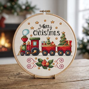 May include: A cross-stitch embroidery in a wooden hoop features a Christmas train with the text "Merry Christmas." The train is red, green, and gold, with a Christmas tree on one of the train cars. The background is a light beige fabric.
