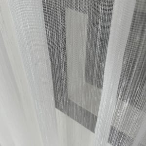 May include: White sheer curtains with a geometric pattern of vertical stripes and squares.