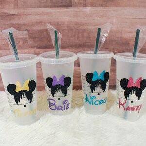 Puede incluir: Cuatro vasos fr&iacute;os de pl&aacute;stico transparente con tapas y pajitas. Cada vaso presenta una silueta negra de Minnie Mouse con un lazo colorido y un nombre en un color coordinado: Tiffany, Brie, Nicole y Kasey. Los vasos est&aacute;n sobre una superficie blanca.