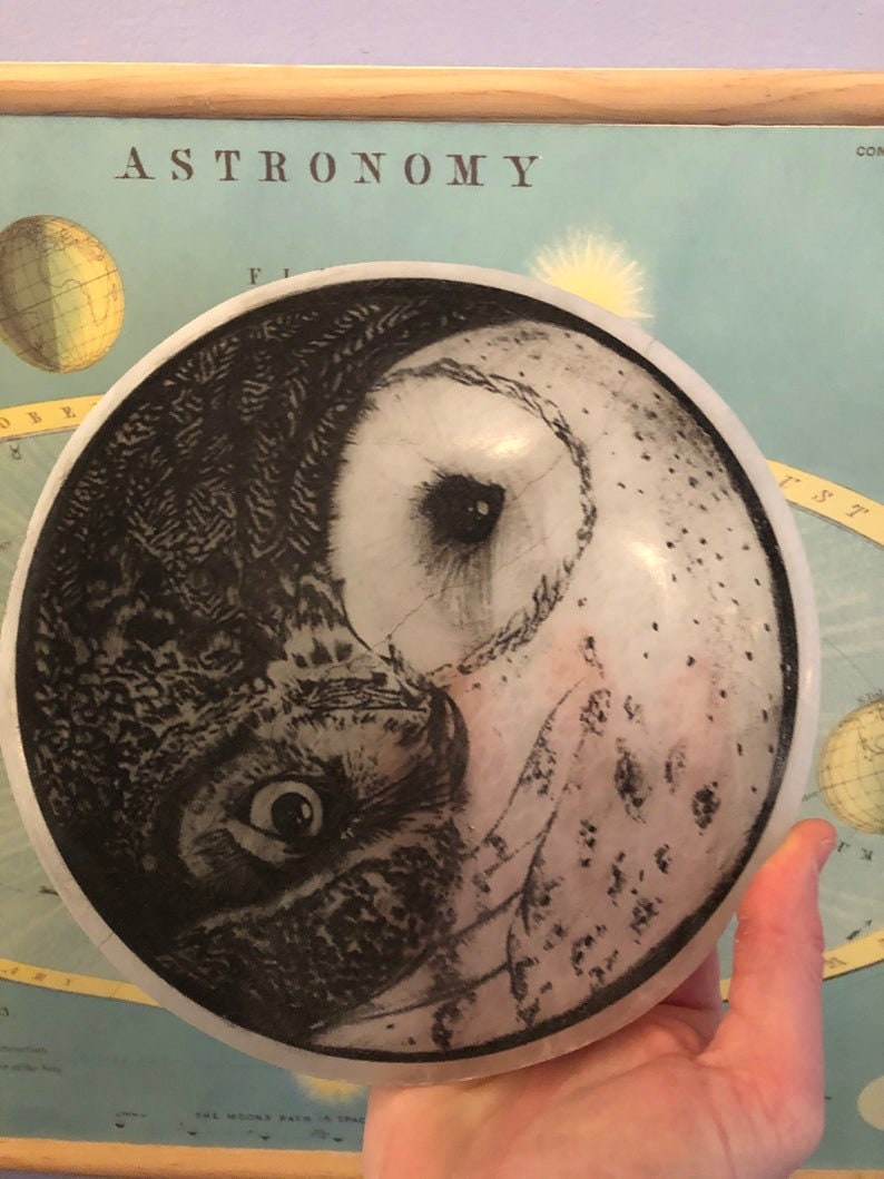 May include: A white ceramic disc with a black and white image of an owl on one side and a white owl on the other side. The image is a yin yang design.