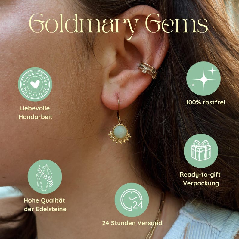 May include: A gold dangle earring featuring a round, pale green gemstone with a beaded edge, worn alongside a gold ear cuff. The image includes the text Goldmary Gems and icons with labels for handmade, rust-free, gift packaging, quality, and shipping.