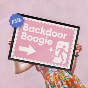 May include: A pink sign with a white arrow pointing right and the text "Backdoor Boogie". The sign is framed in black and has a scalloped edge.