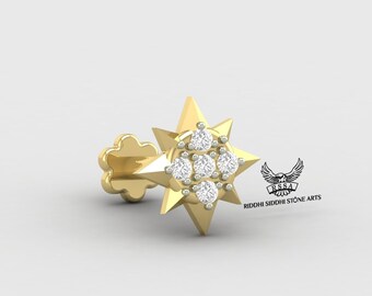 May include: A gold star-shaped nose ring with a cluster of clear round diamonds in the center. The ring is designed with a pointed star shape and a small flower-shaped base.