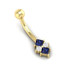 May include: Gold belly button ring with a curved bar and a cluster of blue and clear square-shaped gemstones.